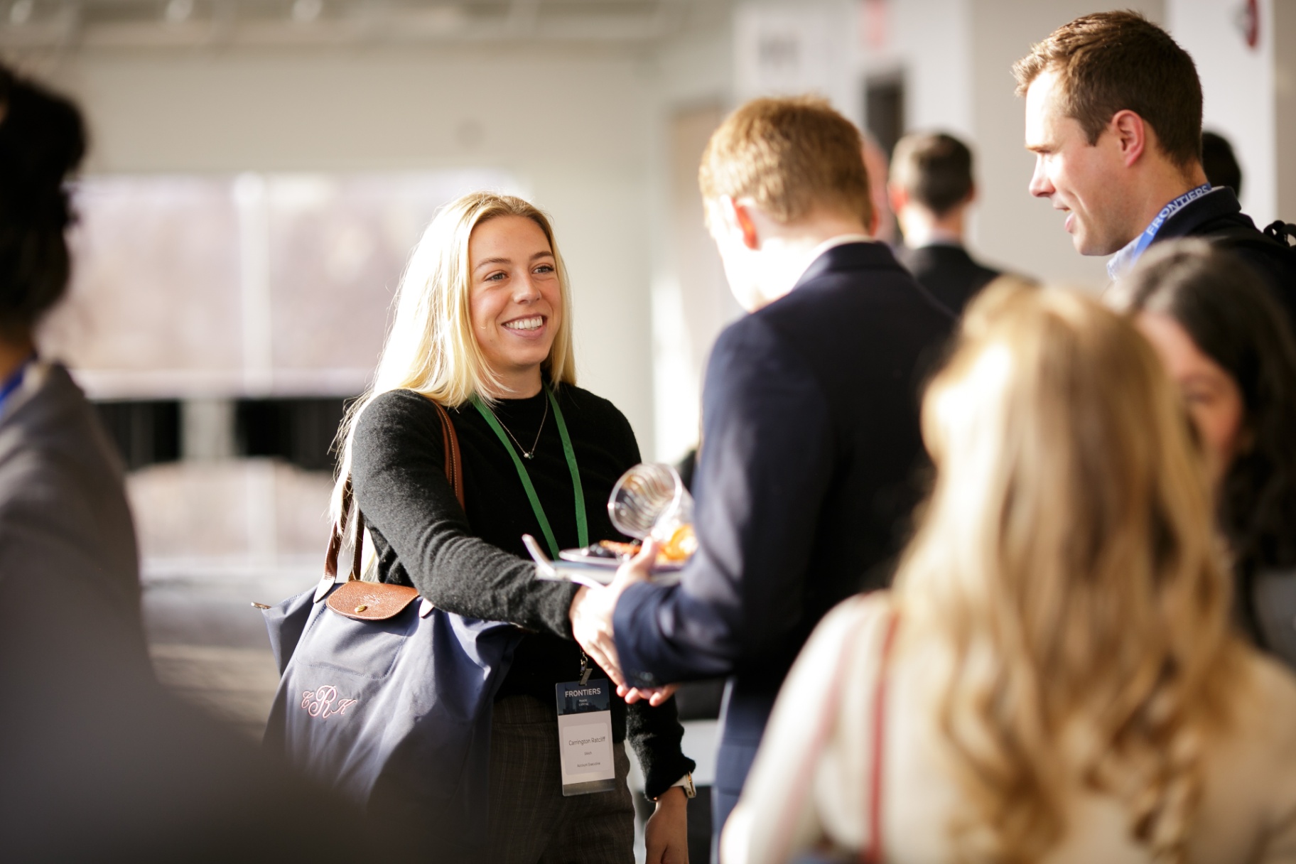 Two attendees connecting and shaking hands at Frontiers 2026