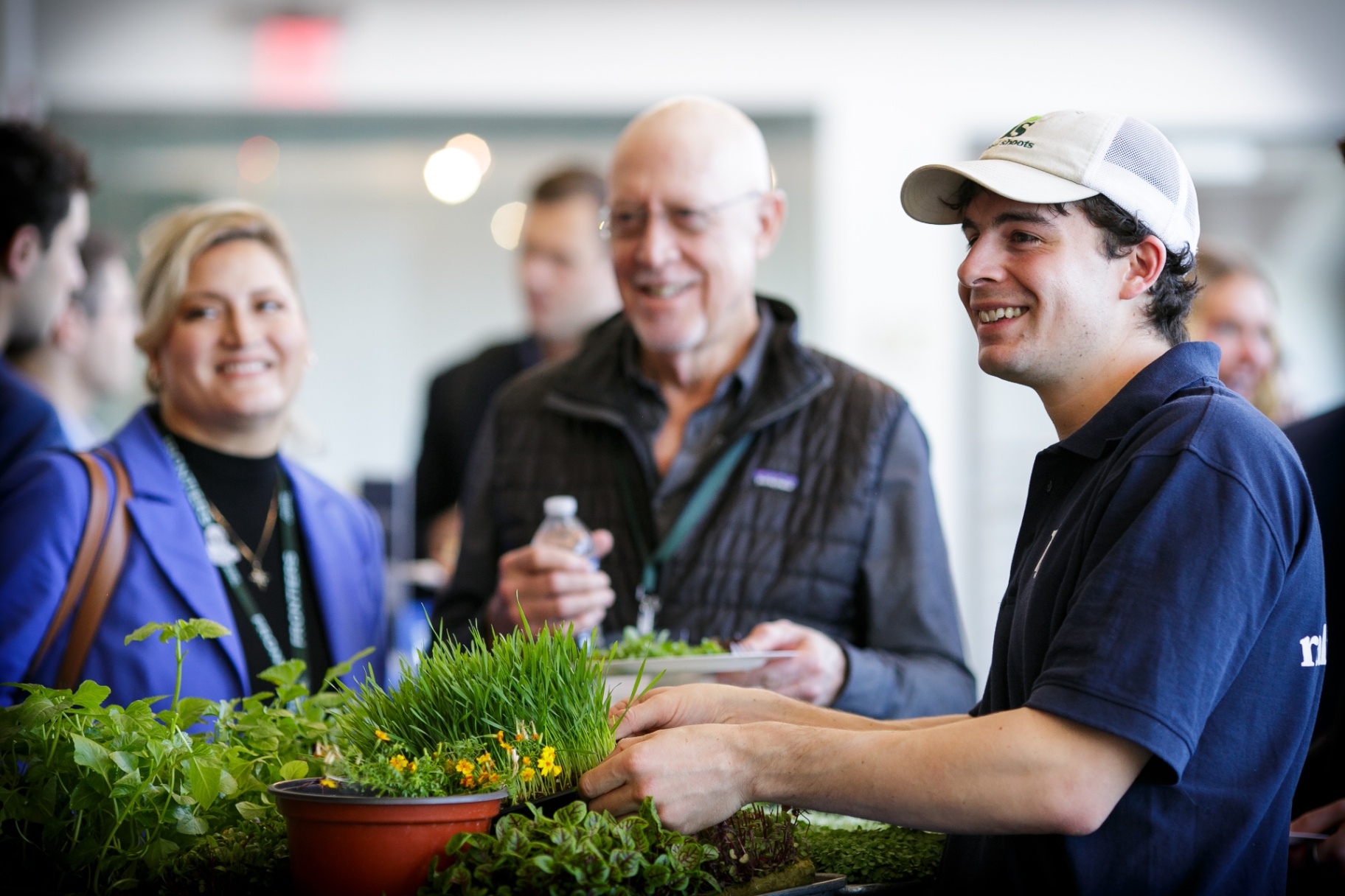Attendees gathered around a fresh microgreens display at Frontiers 2026