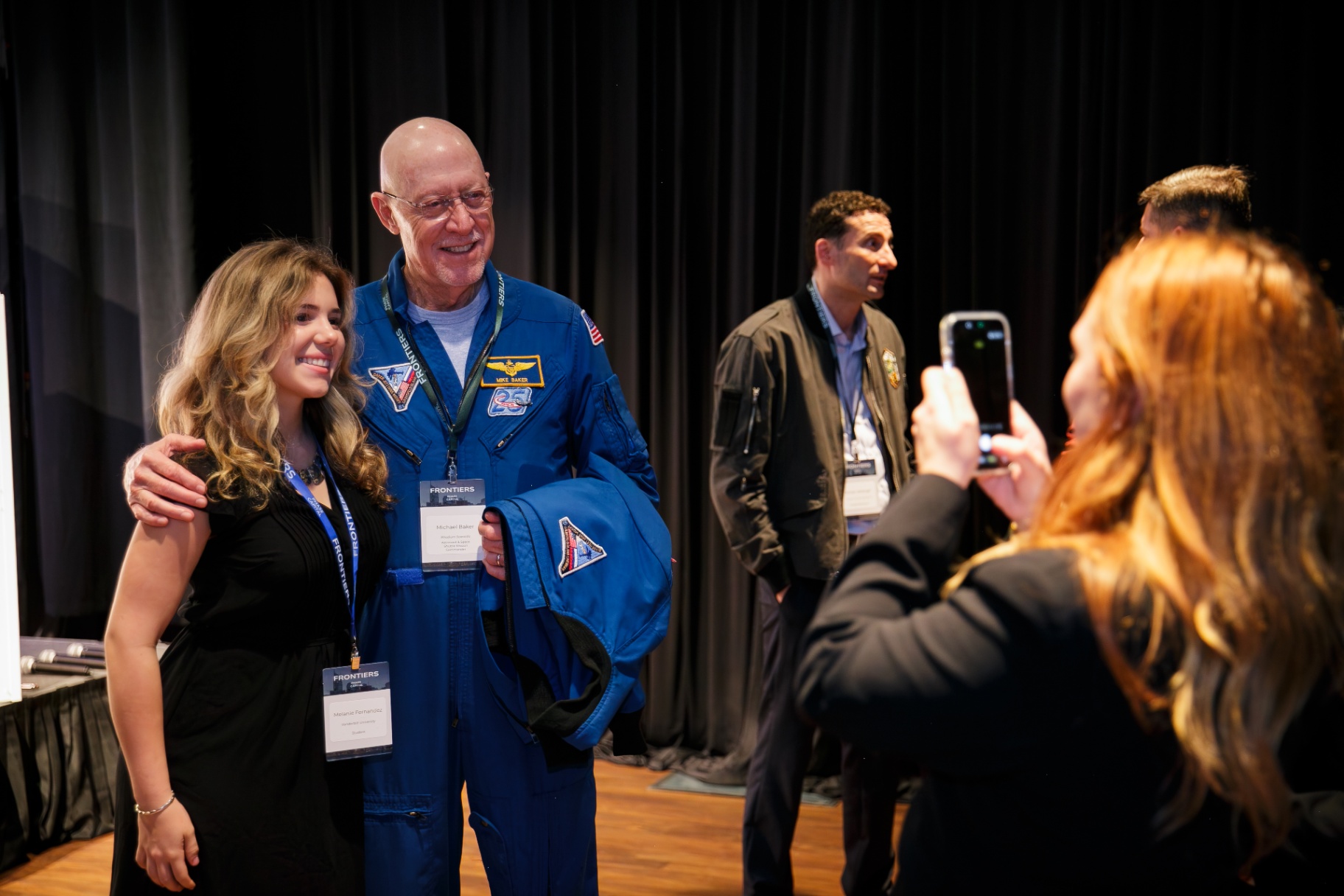 Astronaut Mike Baker posing for a photo with a Frontiers attendee